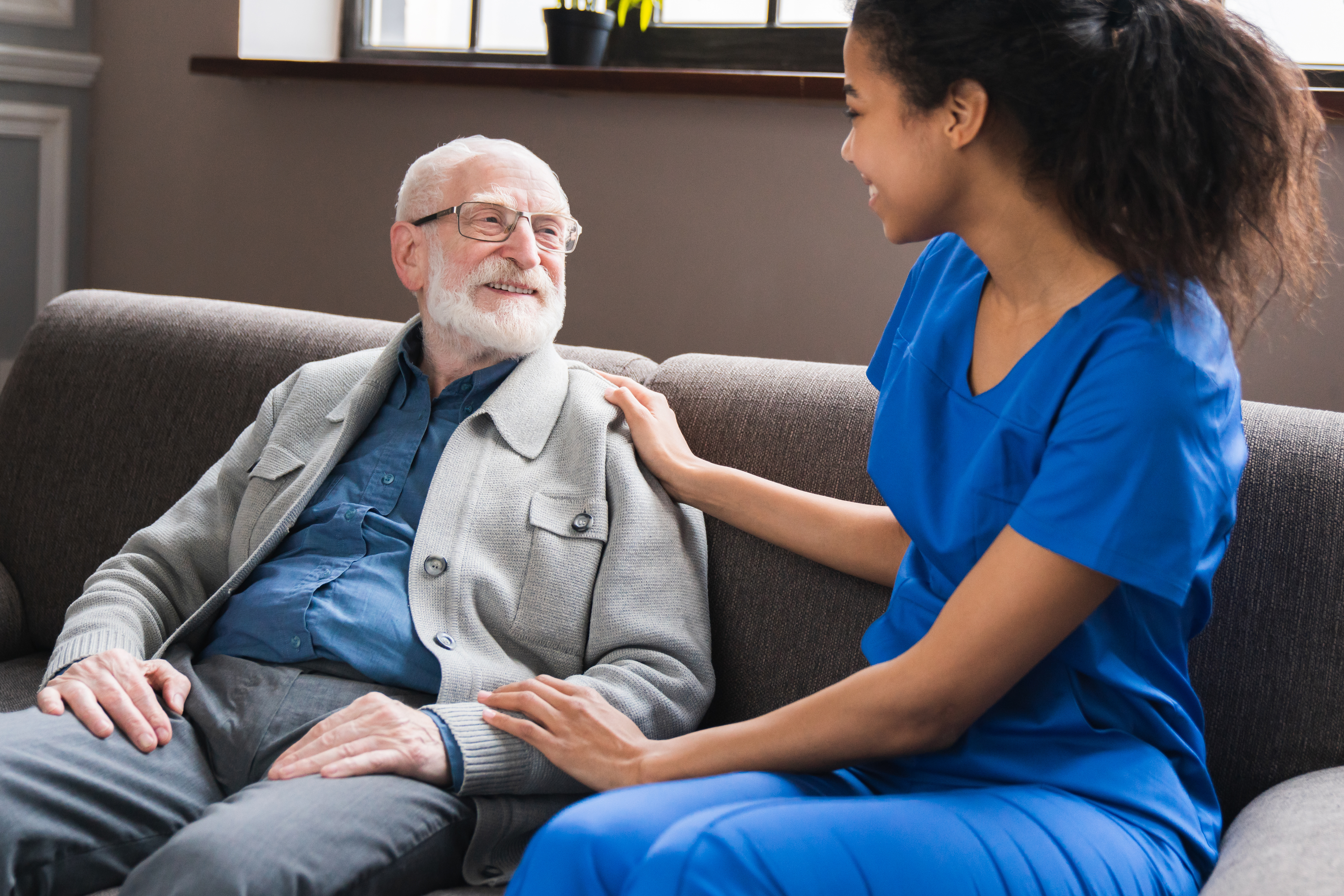 nurse speaking to older man